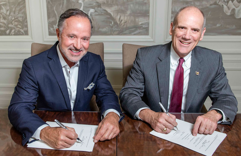 Greg Parker and Allen Amason signing the agreement