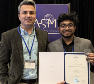 Georgia Southern student and staff member holding an engineering award.