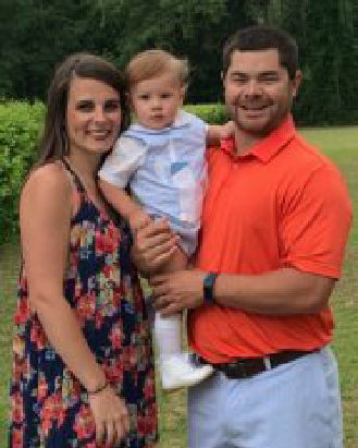 Photo of Georgia Southern MAT alum Benjamin Mitchell, ’20, stands outdoors with his family