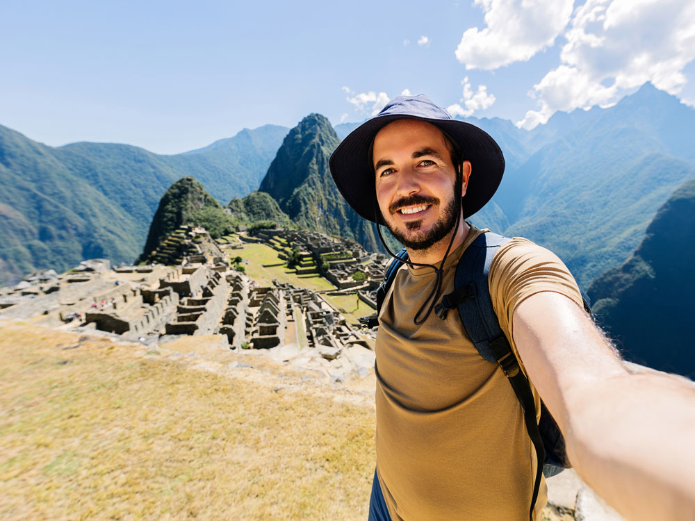 A Georgia Southern Student poses in front of historical ruins while completing his masters in spanish online.