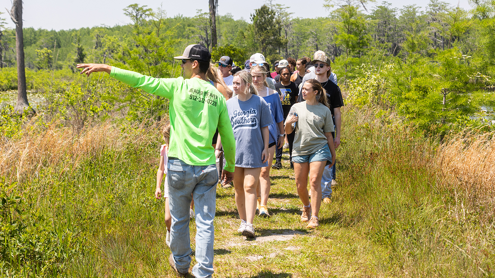 A group of people walking while a guide is navigating them