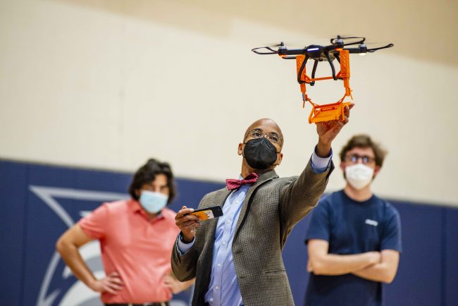 Wayne Johnson, Ph.D., examines a drone in preparation for the Engineering Design Challenge. 