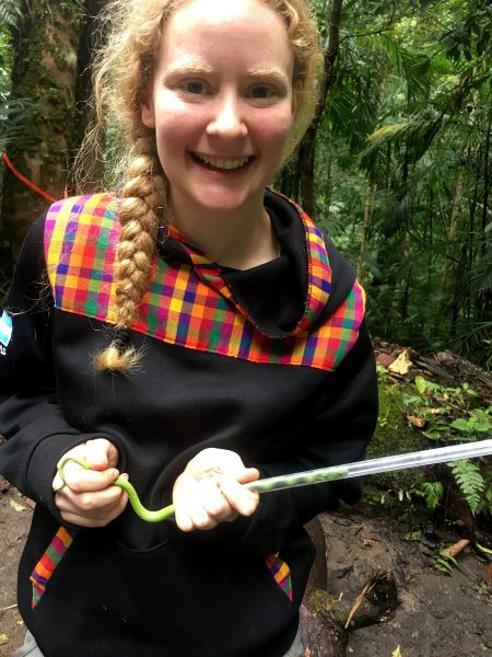 Georgia Southern graduate student Lauren Wilson helps guide a snake into a tube to be studied.
