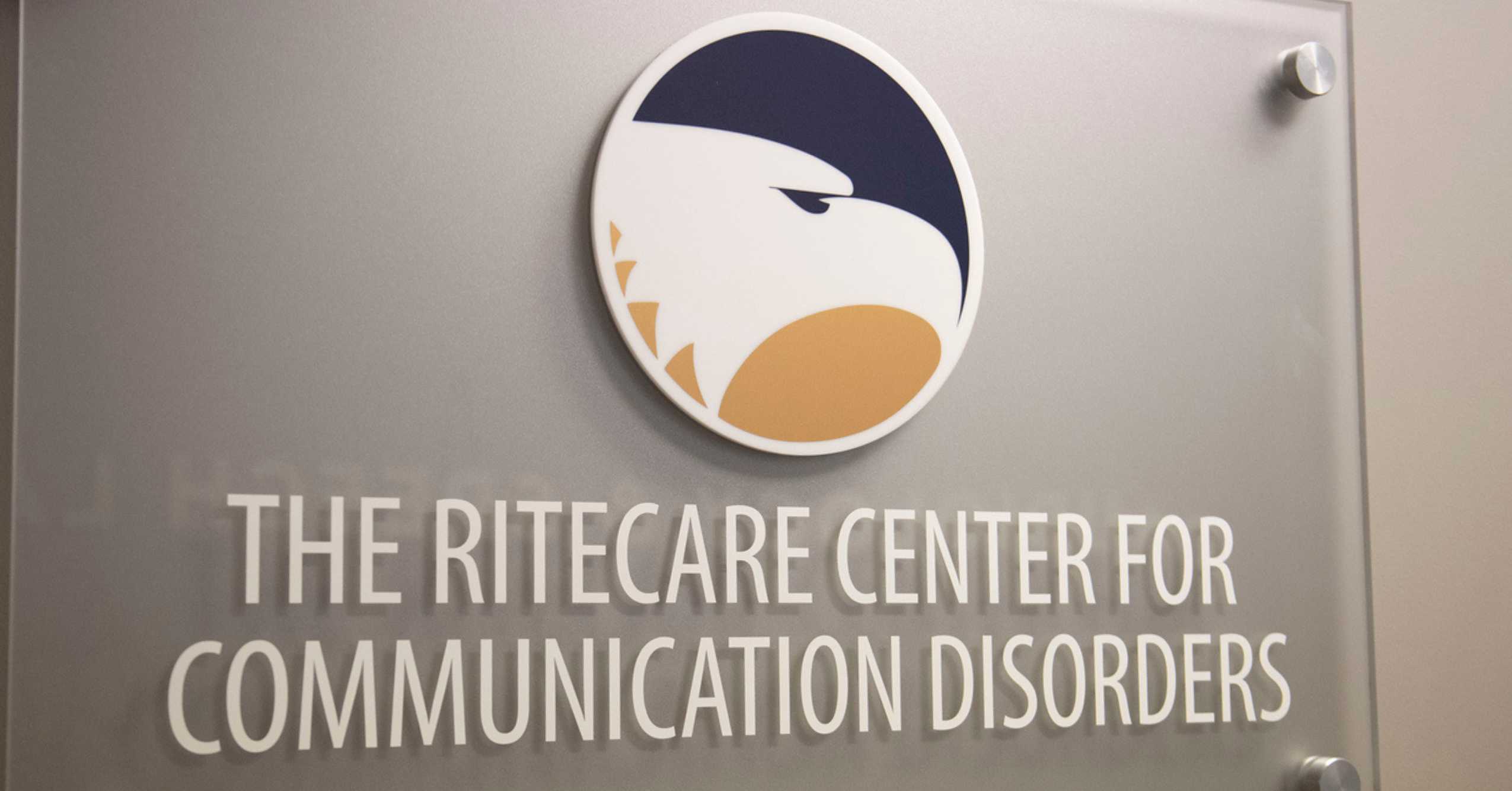 The Georgia Southern eagle logo sits in a circle on a rectangular sign that says "THE RITECARE CENTER FOR COMMUNICATION DISORDERS"
